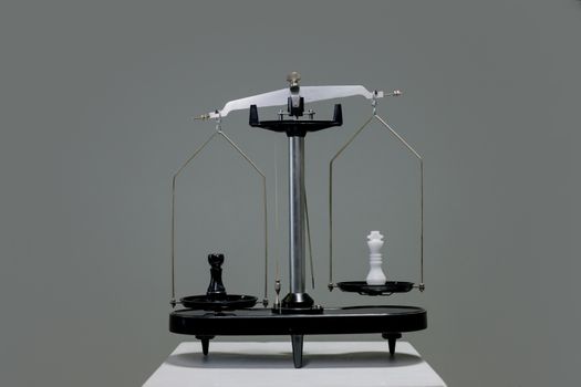 Chess pieces balanced on a scale representing a directory comparison
